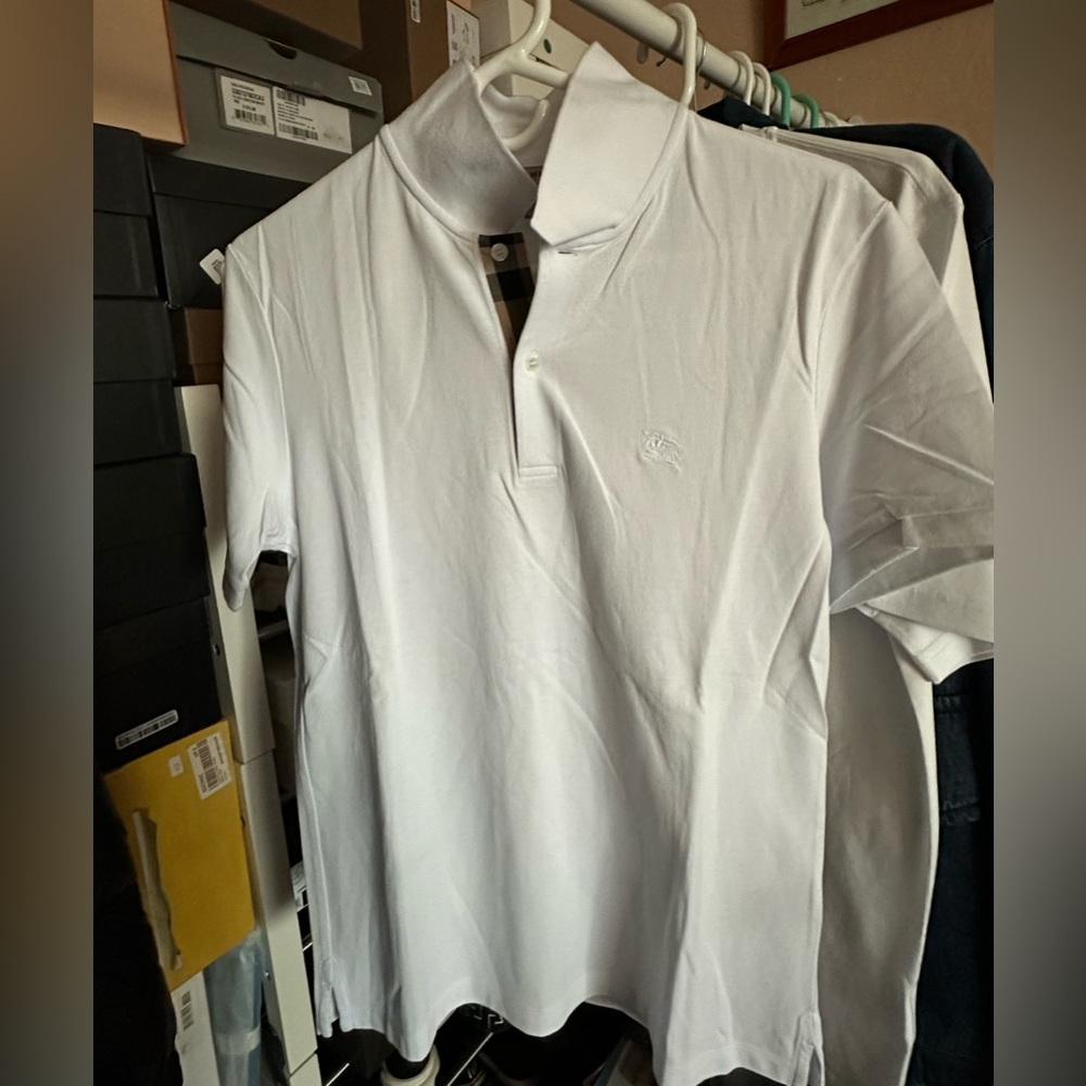 Burberry polo finished with monogram logo embroidery at the chest.